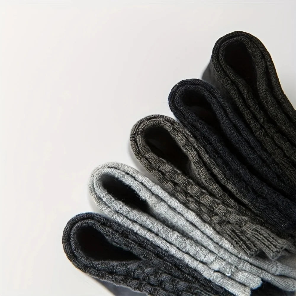 Set of men's socks in various shades of gray and black, made from soft, breathable fabric.