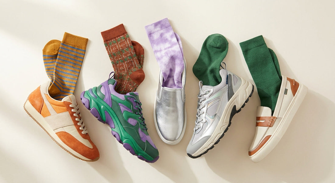 A flat-lay arrangement of colorful bamboo crew socks paired with various trendy 2026 sneaker styles on a clean off-white surface.
