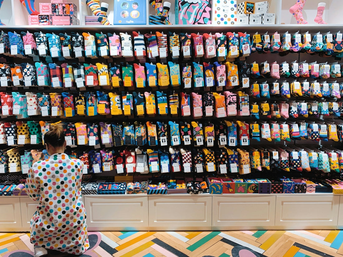 woman crouching in front of display shelf