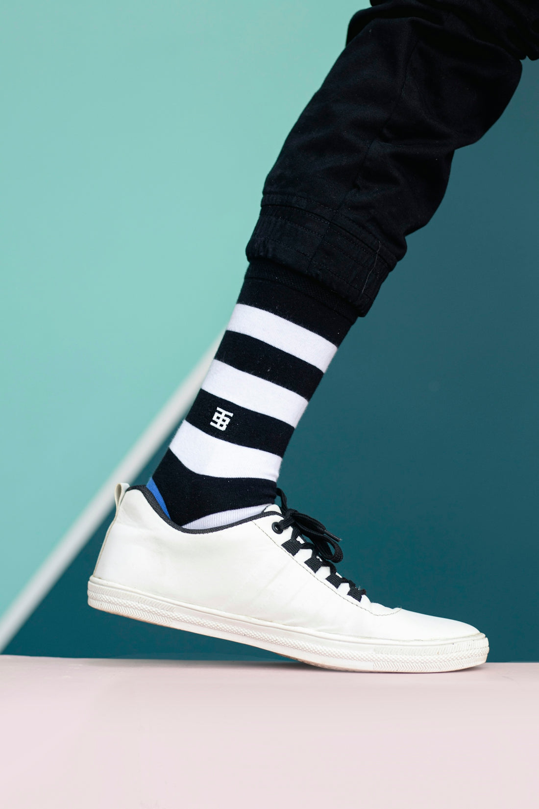 a person wearing black and white striped socks