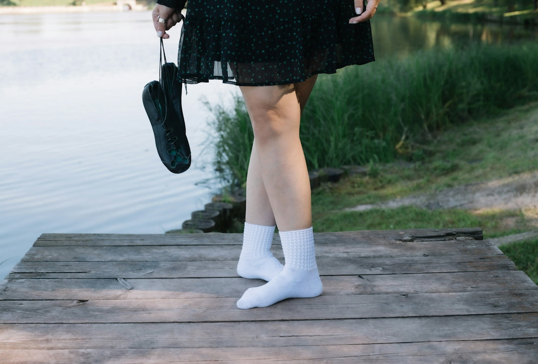 a woman standing on a dock holding an umbrella
