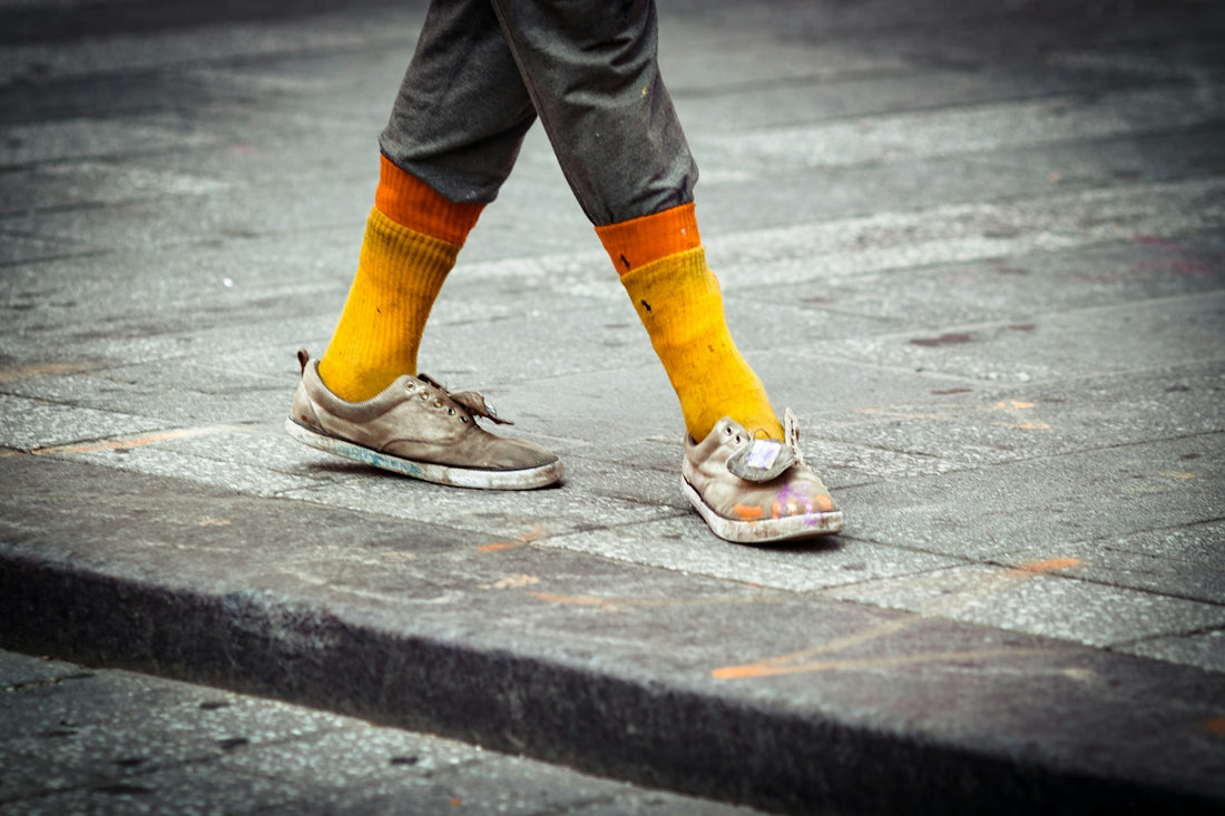 A person walking down a street with colorful socks
