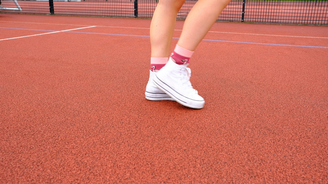 A woman standing on a tennis court holding a racquet