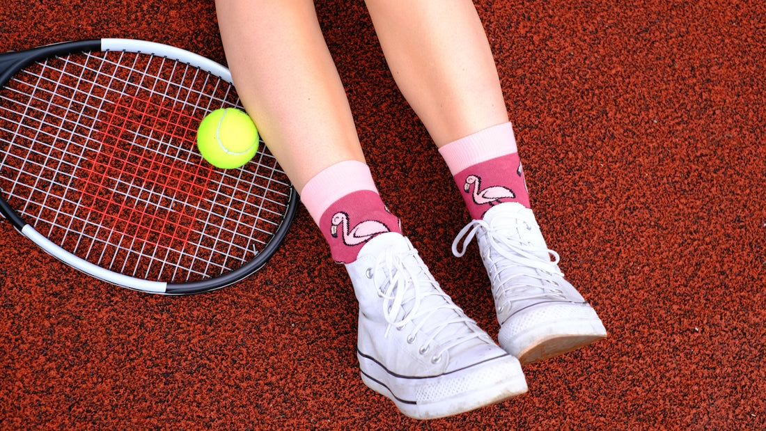 A tennis player's feet and racket on a court