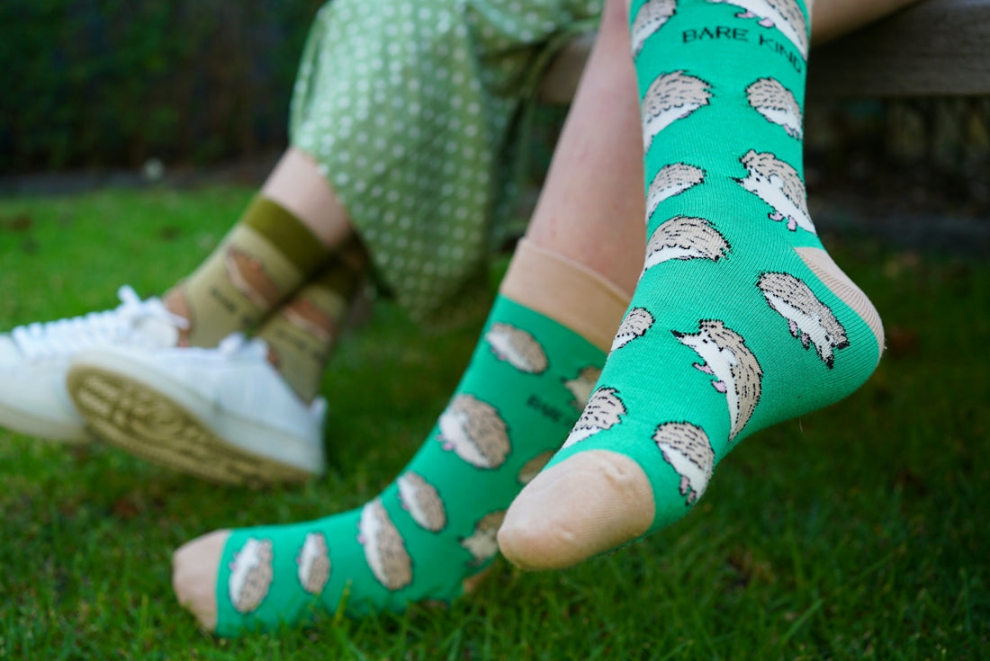 A person sitting on a bench wearing green socks