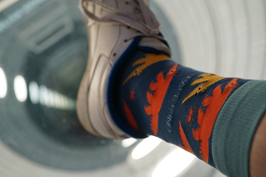 A person's legs with colorful socks and socks on