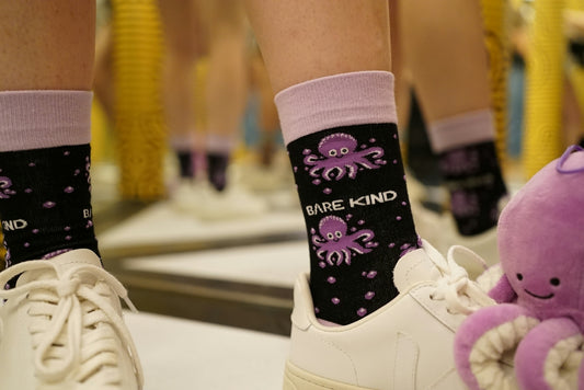 A close up of a person's legs with octopus socks