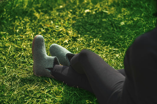 Someone relaxing in the grass with socks.