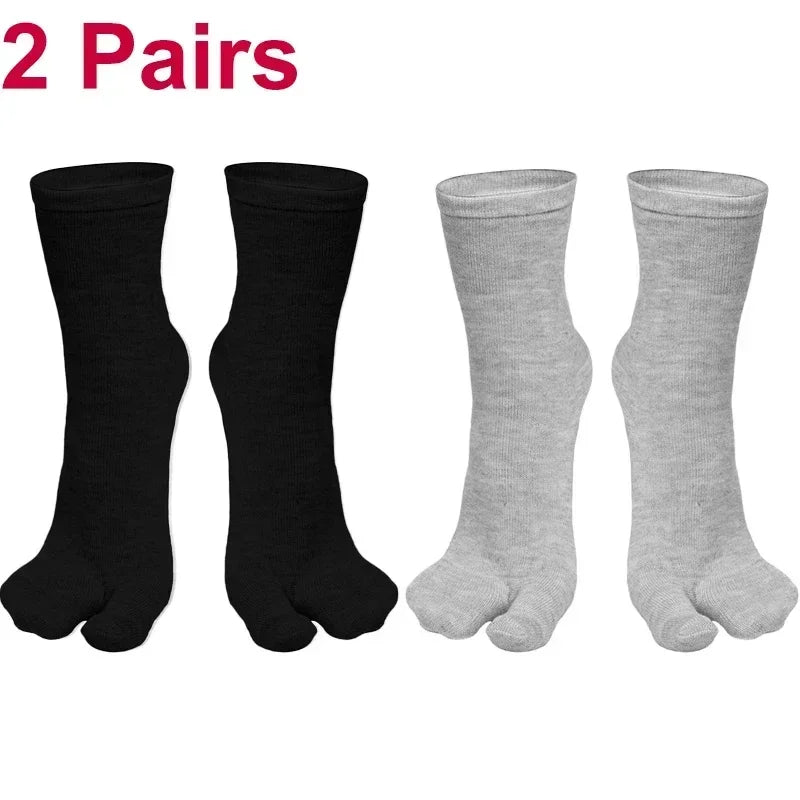 Two pairs of toe socks in black and grey, made from soft, breathable cotton for comfort.