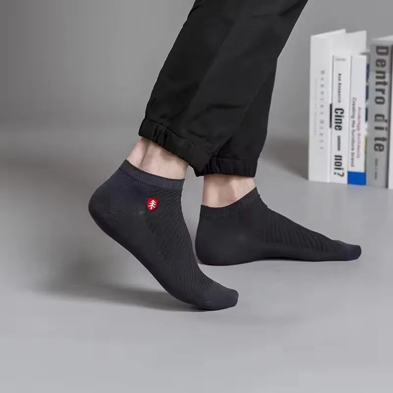 Men's black ankle socks with breathable fabric and logo, ideal for everyday wear and comfort.