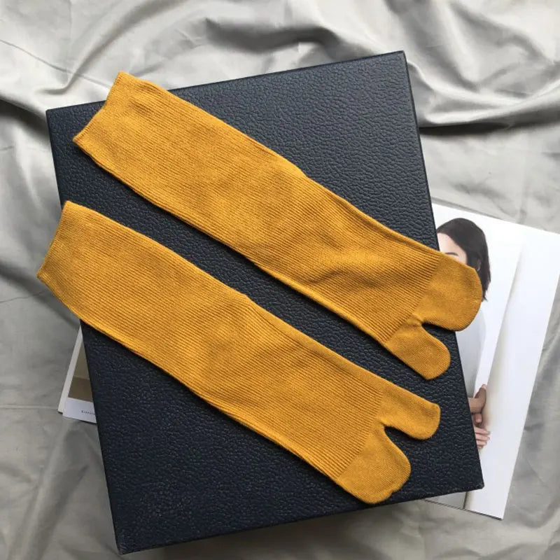 Mustard yellow leg warmers, ribbed knit material, perfect for style and warmth.