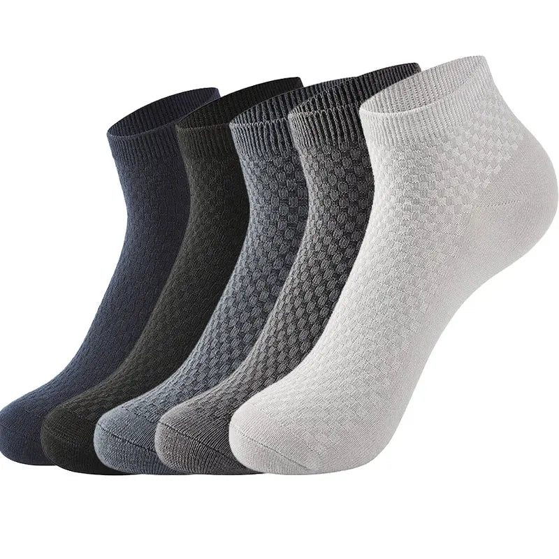 Five pairs of stylish, patterned crew socks in dark navy, black, charcoal, gray, and light gray colors.