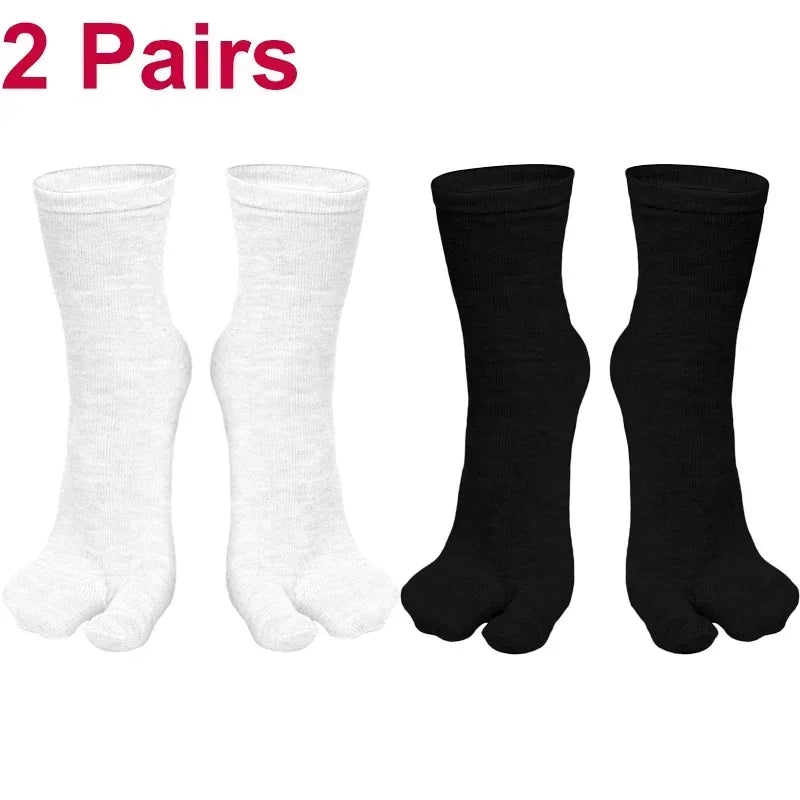 Two pairs of cozy cotton socks in white and black, perfect for comfort and style.