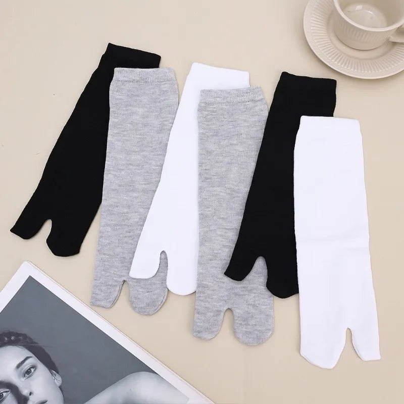 Set of five toe socks in black, white, and gray cotton, perfect for comfort and style.