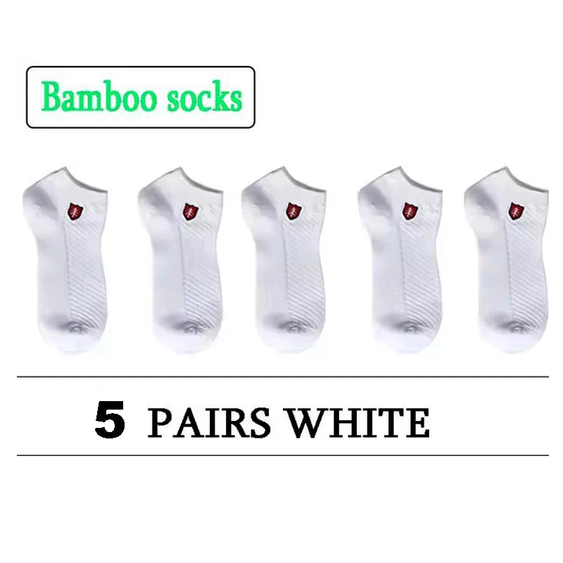 5 pairs of white bamboo socks with breathable material and ribbed design for comfort.