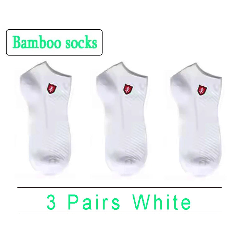 Set of 3 pairs of white bamboo socks with logo, soft, breathable, and moisture-wicking material.