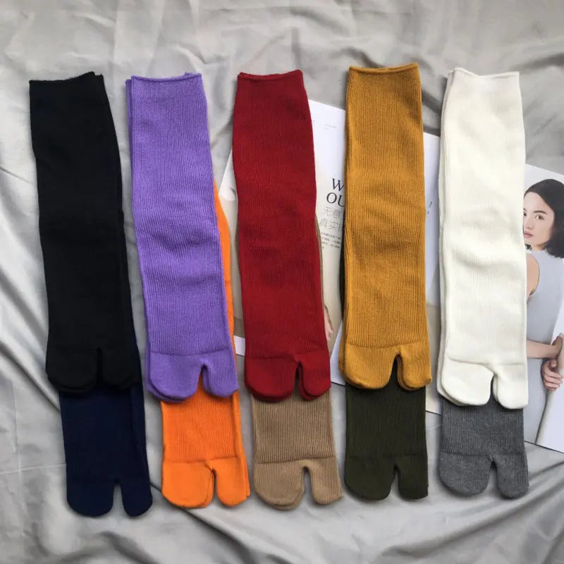 Colorful ribbed tabi socks in various hues: black, purple, red, orange, yellow, white, gray.